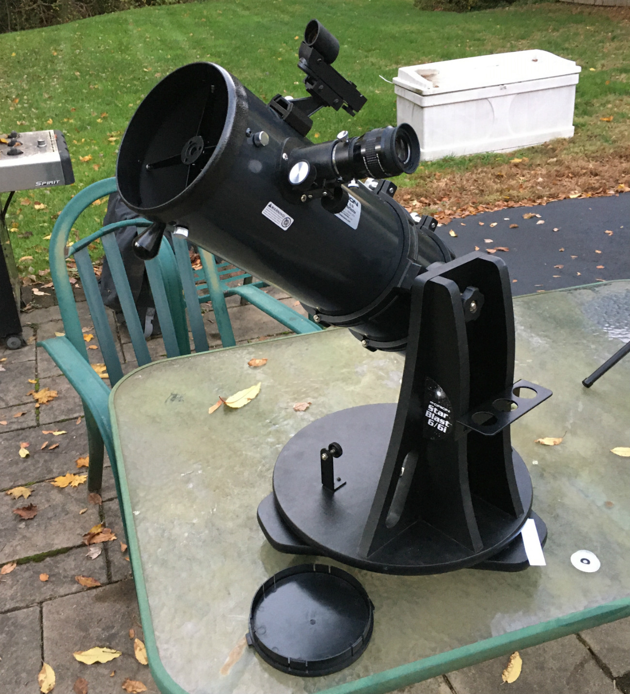 Orion's StarBlast 6 tabletop dobsonian telescope on a table on field