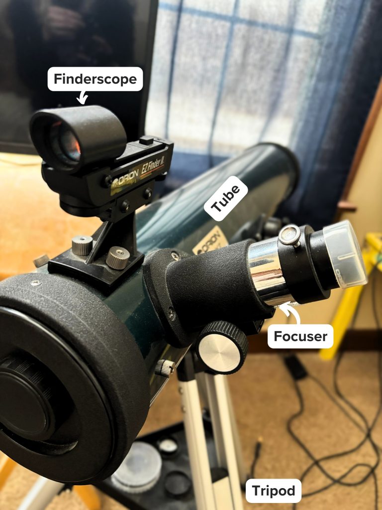 Orion SpaceProbe 76EQ telescope with its optical tube, tripod, focuser and finderscope marked