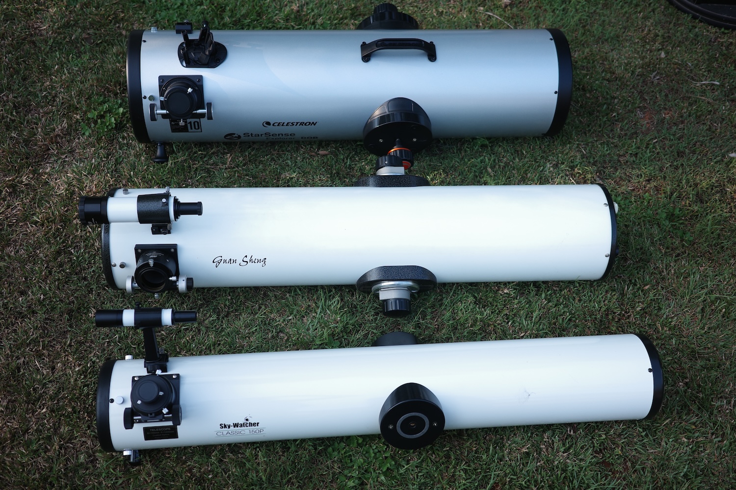 Dobsonian optical tubes laid on the ground to showcase its similar physical length